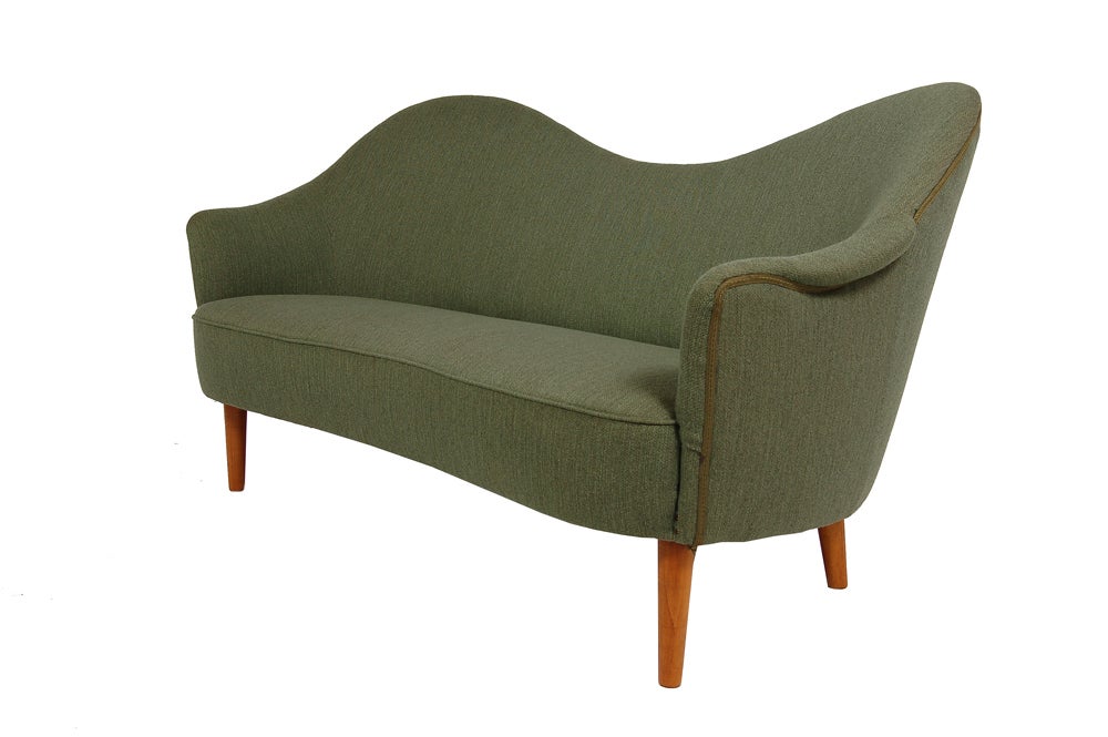 Curving camel-back sofa with spring seat construction, tapering birch legs and sculptural arms.  In original wool upholstery. Made by AB Record, Bollnäs, Sweden.