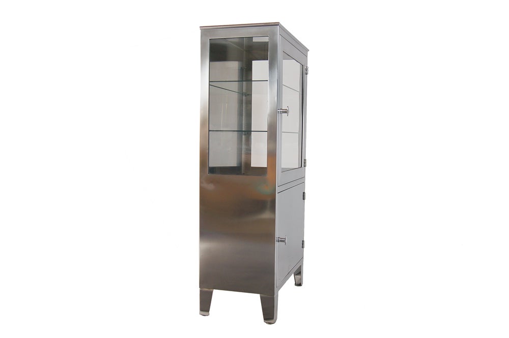Two door stainless steel cabinet with glass top and sides, and storage space with shelves below.  Inside depth, 15.25