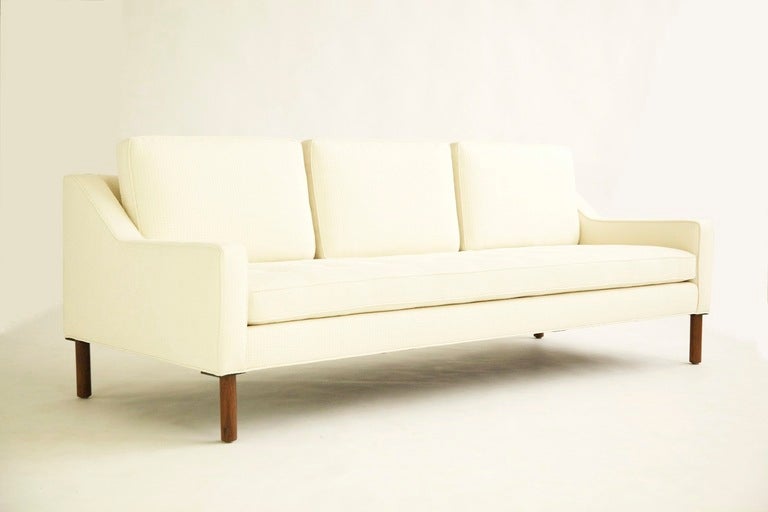 Risom for Risom Design Inc. Three seat sofa,Model 2534
 Separate back cushions, buttoned seat cushion, Turned solid walnut lens.
 Reupholstered with Great Plains fabric.
