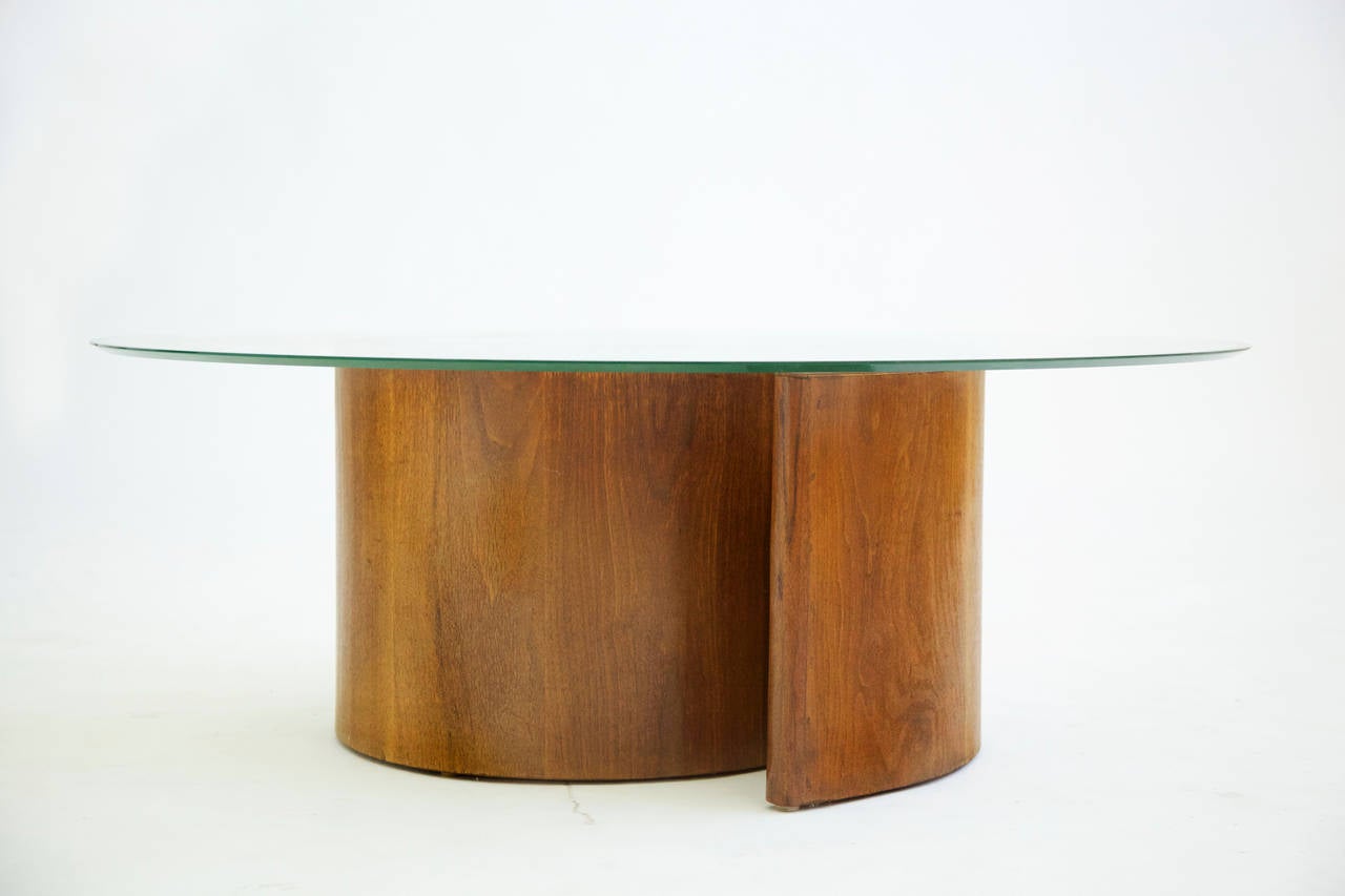 Round beveled glass floats on top of this spiraled platform in walnut. The glass top reveals the beauty of this piece, showing sculpture, form and depth within the table.