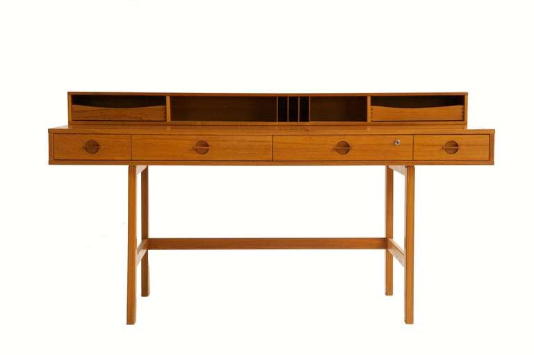 Jens Quistgaard, Rosewood Flip-Top Desk

Quistgaard created this 1967 piece, which has a rectangular top with a hinged flip-top superstructure and is fitted with drawers and pigeonholes above a four-drawer frieze. It was manufactured by Lovig.

