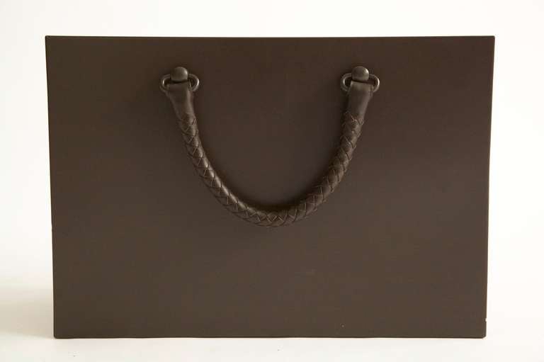  Bottega Veneta Leather and Metal Newspaper Caddy
in the form of a shopping bag with woven leather handles. 
numbered plate 0462.
no longer in production.

