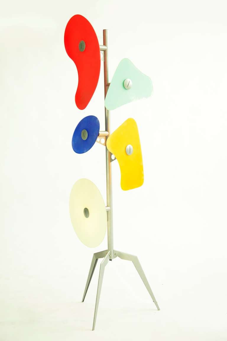 Orbital by Foscarini is a floor lamp constructed of colored glass plates in various shapes in silkscreen-printed glass, mounted on a lacquered metal structure.