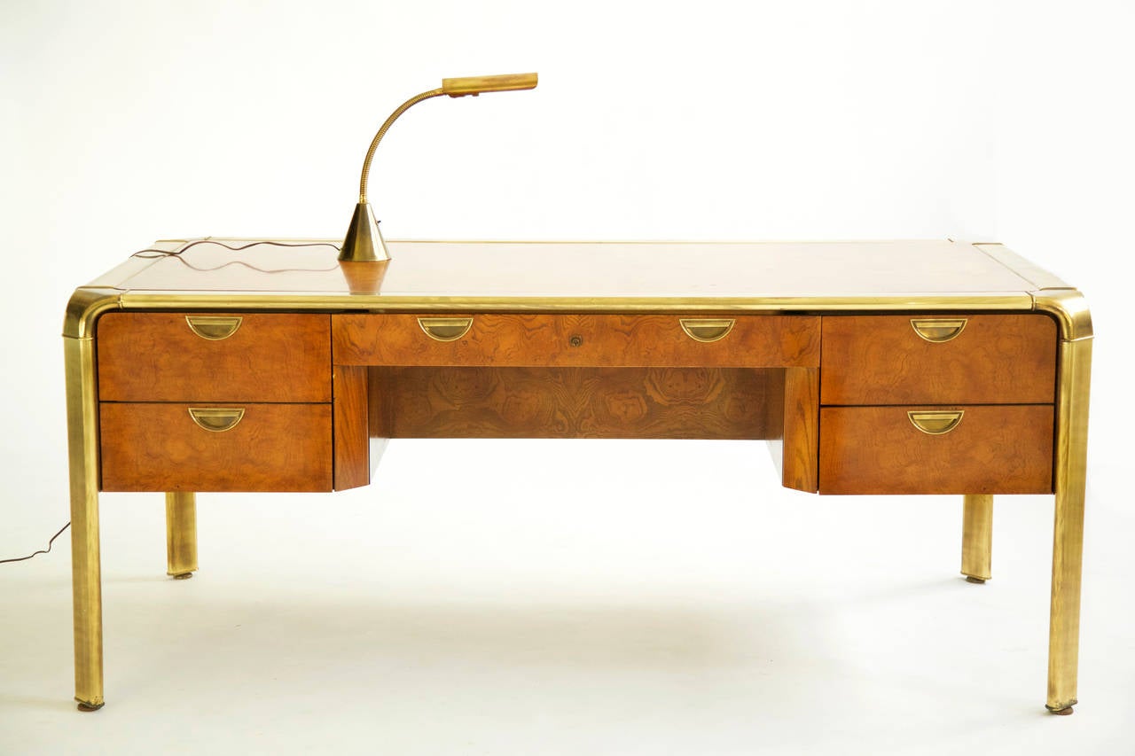 Brass and burled-wood three-drawer desk by Widdicomb. Waterfall corner details connect legs and horizontal supports, half-moon inset brass pulls. 
[Label on inside drawer John Widdicomb].