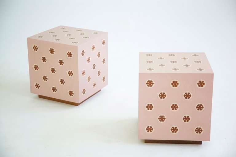Wormley inspired parquetry end tables on plinth bases. Pale pink poly surface with wooden impressed medallion designs.