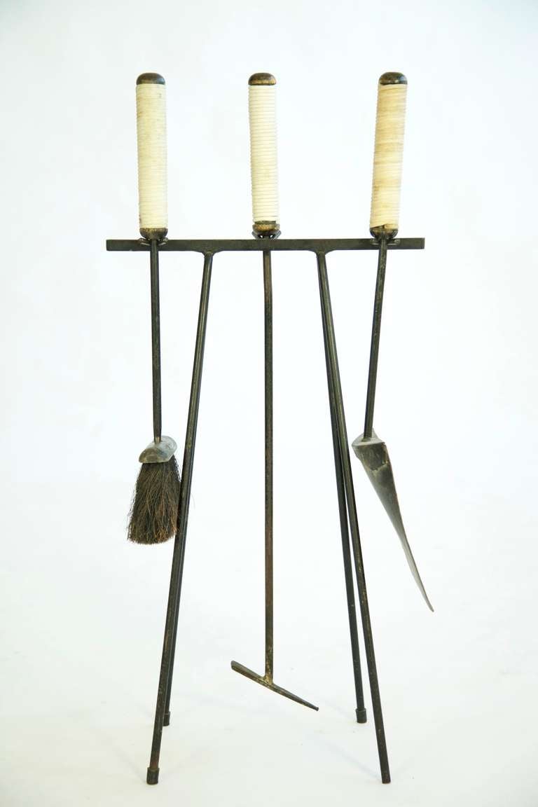Set of wrought iron and rope poker, shovel and brush.