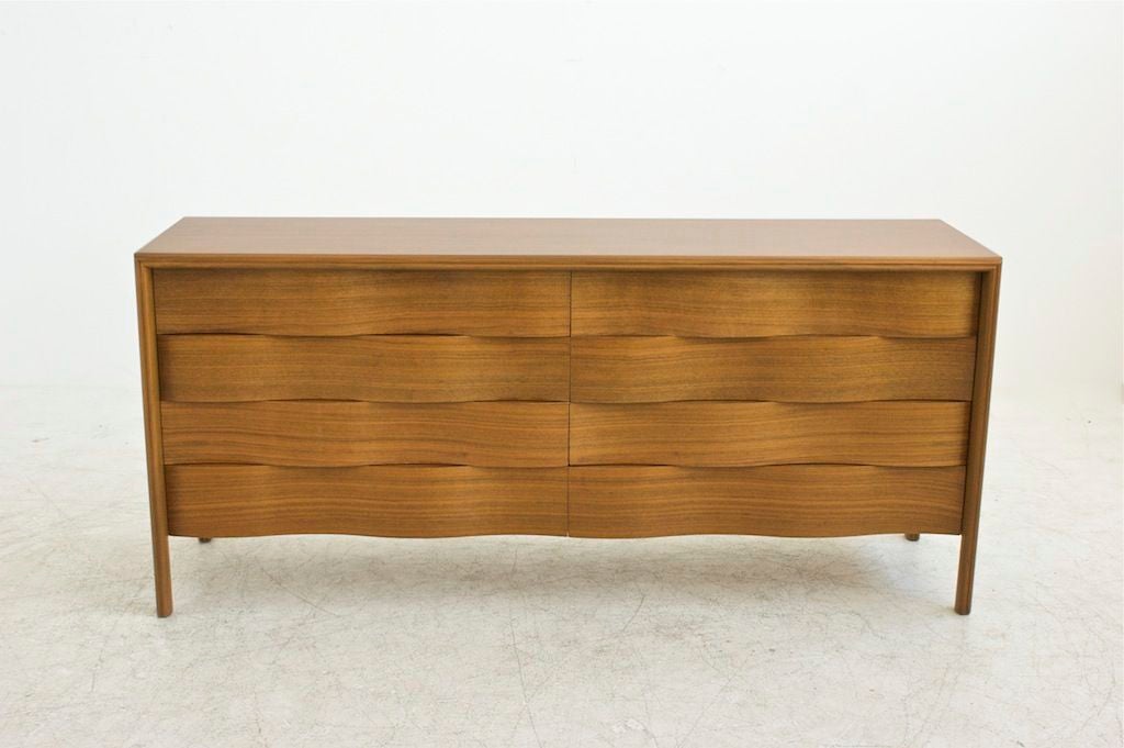 EDMUND SPENCE, Eight drawer wavy front double dresser <br />
<br />
Signed with stamped manufacturer’s mark to reverse: [Made in Sweden Factory No. 14].