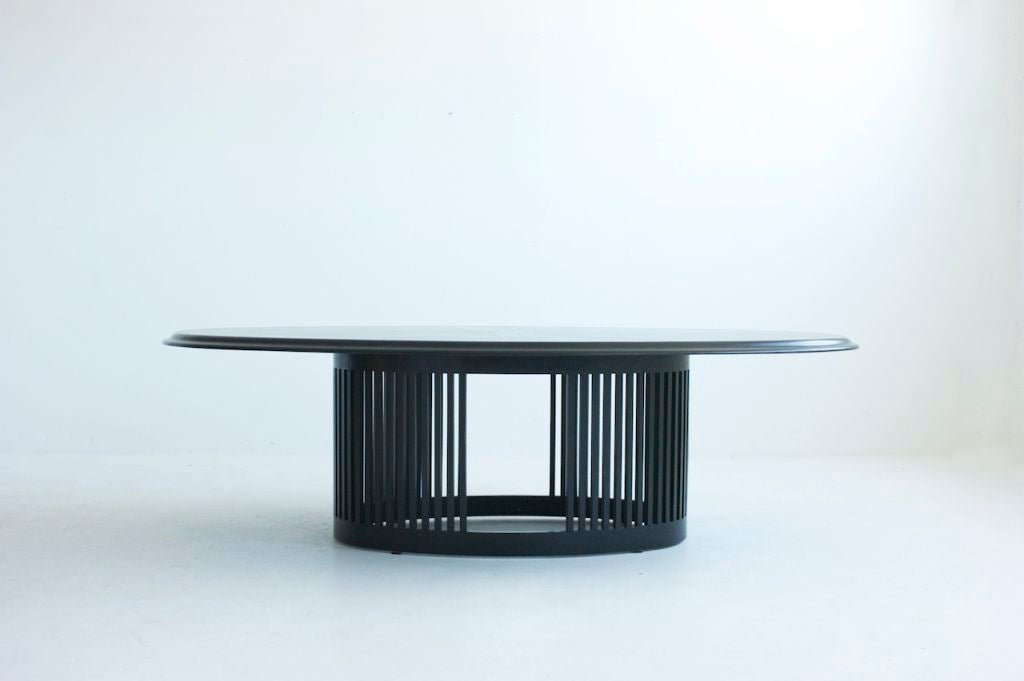 Arata Isozaki, for ICF Oval Dining table, Features, Oval vertical slated pedestal base with Starburst veneer pattern in ebonized beech and 1.75