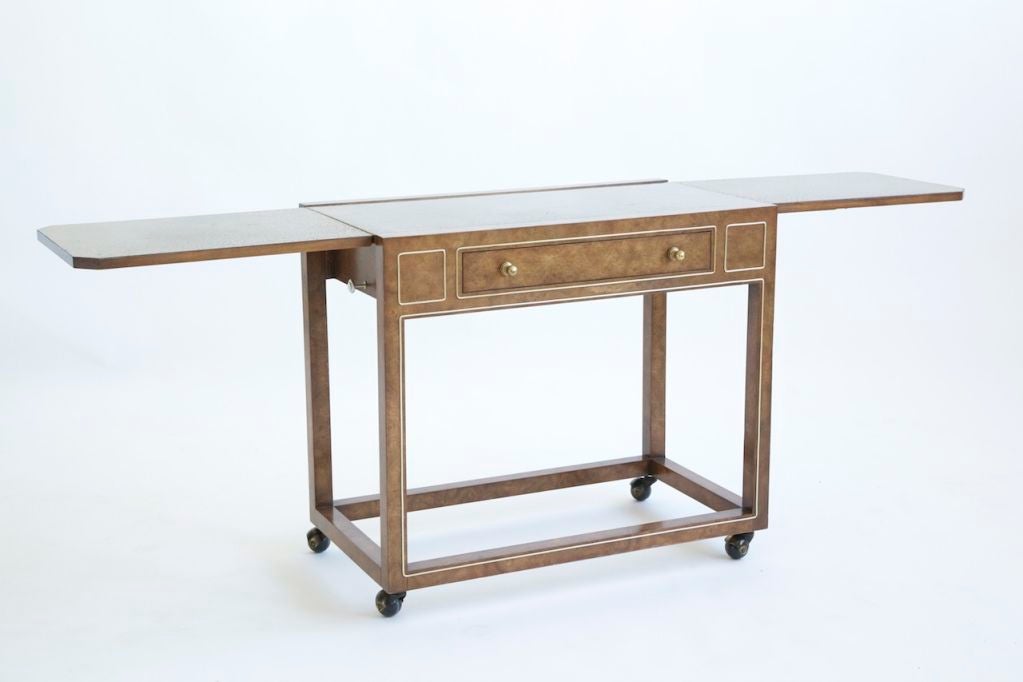 Features 2 drop leaf surfaces, that have a metal hammered look,<br />
Single drawer
