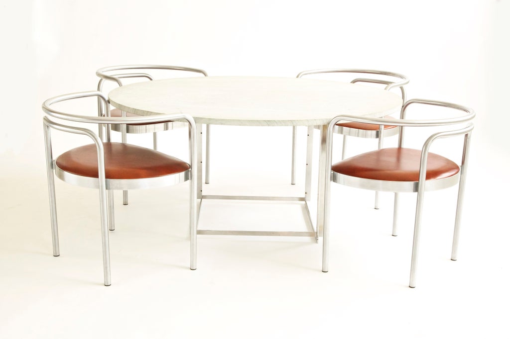 Rare dining set by Kjearholm for E.Kold Christian
Table:PK 54 dining table
E. Kold Christensen flint-rolled Cippolino marble, matte chrome-plated steel
55 dia x 27 h inches
Signed with impressed manufacturer’s mark to base.

Chairs; Set of