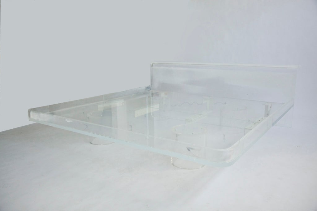 Lucite bed features, round silo legs, Headboard curves back shelf 19