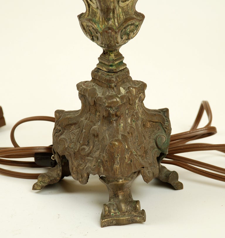 A 17th century Italian baroque bronze pricket lamp with beautiful hand chasing and repousse. Modern parchment shade. Professionally rewired. 

Dimensions: 23 inches high to top of shade. 