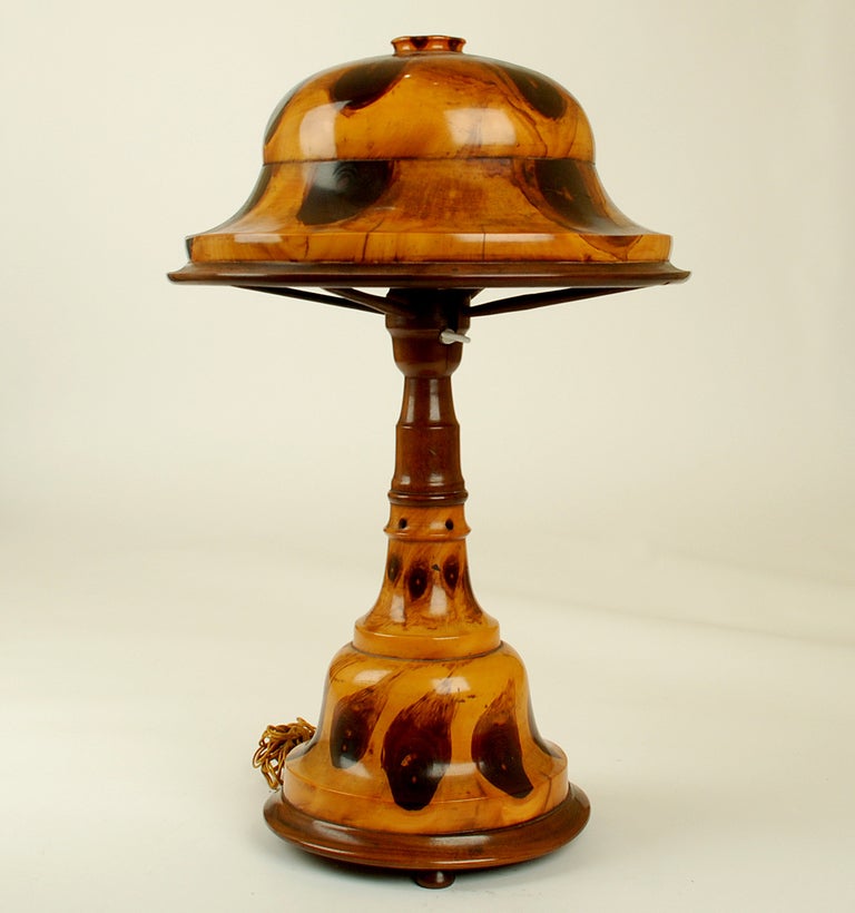 A gorgeous early 20th century Brazilian table lamp in hand turned 'butterfly' wood. The lamp, with two sockets, is lit from both the base and the shade. In pristine condition. Circa 1920. 

Dimensions: measures 20.5 inches high. Shade measures 13