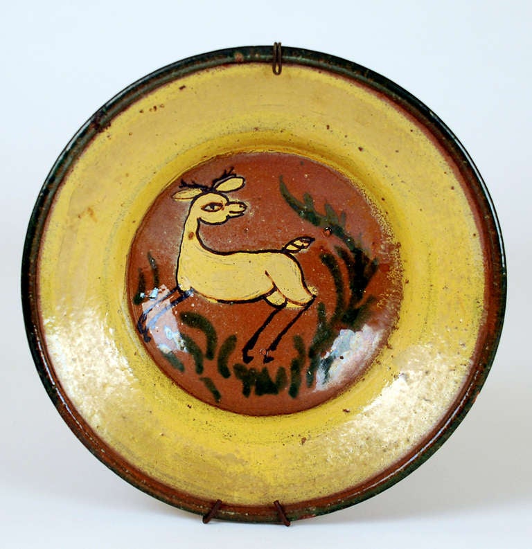 A very fine and rare late 19th century 'Montiel' plate from the 'Montiel Family Studio' in Antigua Guatemala.  A playful deer surrounded by foliage and yellow ring borders. See Marion Oettinger's 'Folk Art of Spain and the Americas' for a similar