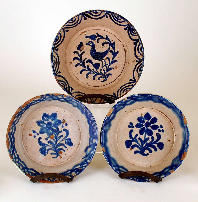 A lot of three good mid 19th century Granadino Fuente chargers from Granada, Spain. Two with classic foliate and grape vine patterns and one with song-bird. Beautiful cobalt glaze over a milky white / salmon colored slip.
See 