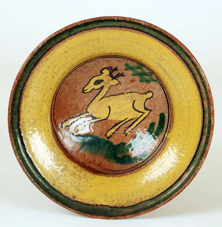 A very fine and rare late 19th century 'Montiel' plate from the 'Montiel Family Studio' in Antigua Guatemala.  A playful deer surrounded by foliage and yellow ring borders. See Marion Oettinger's 'Folk Art of Spain and the Americas' for a similar