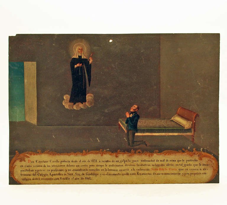 This extremely fine and rare 19th century ex-voto is dedicated to Santa Rita de Casia, levitating in upper left. According to the written testimonial, Don Cayetano Carillo suffered from the year 1828, the result of a collision. He was suffering from