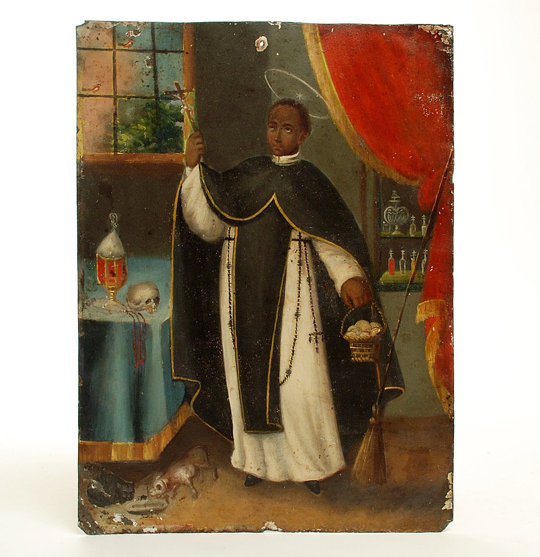 San Martin de Porres, patron saint of black people, mixed races, the impoverished, hair stylists and public educators, is depicted in this exceptionally rare 19th century Mexican retablo. In retablo art, San Martin is almost always accompanied by a