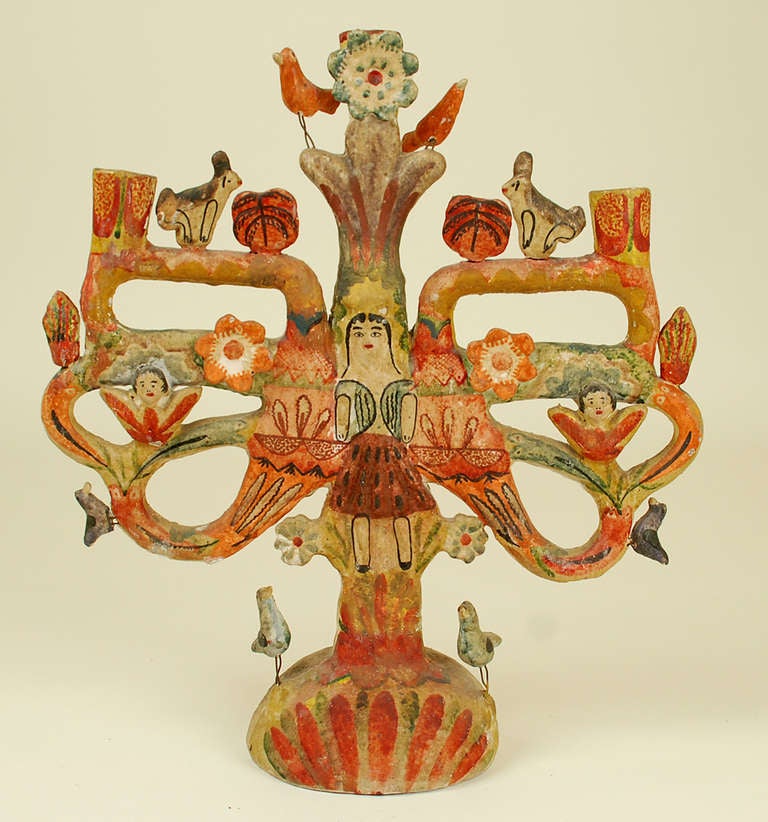 A large and impressive vintage Mexican tree of life candelabrum with the Archangel Gabriel surrounded by birds, rabbits and colorful flower blossoms. Overall with a richly colored palette and good surface patina. Attributed to one of Mexico's great