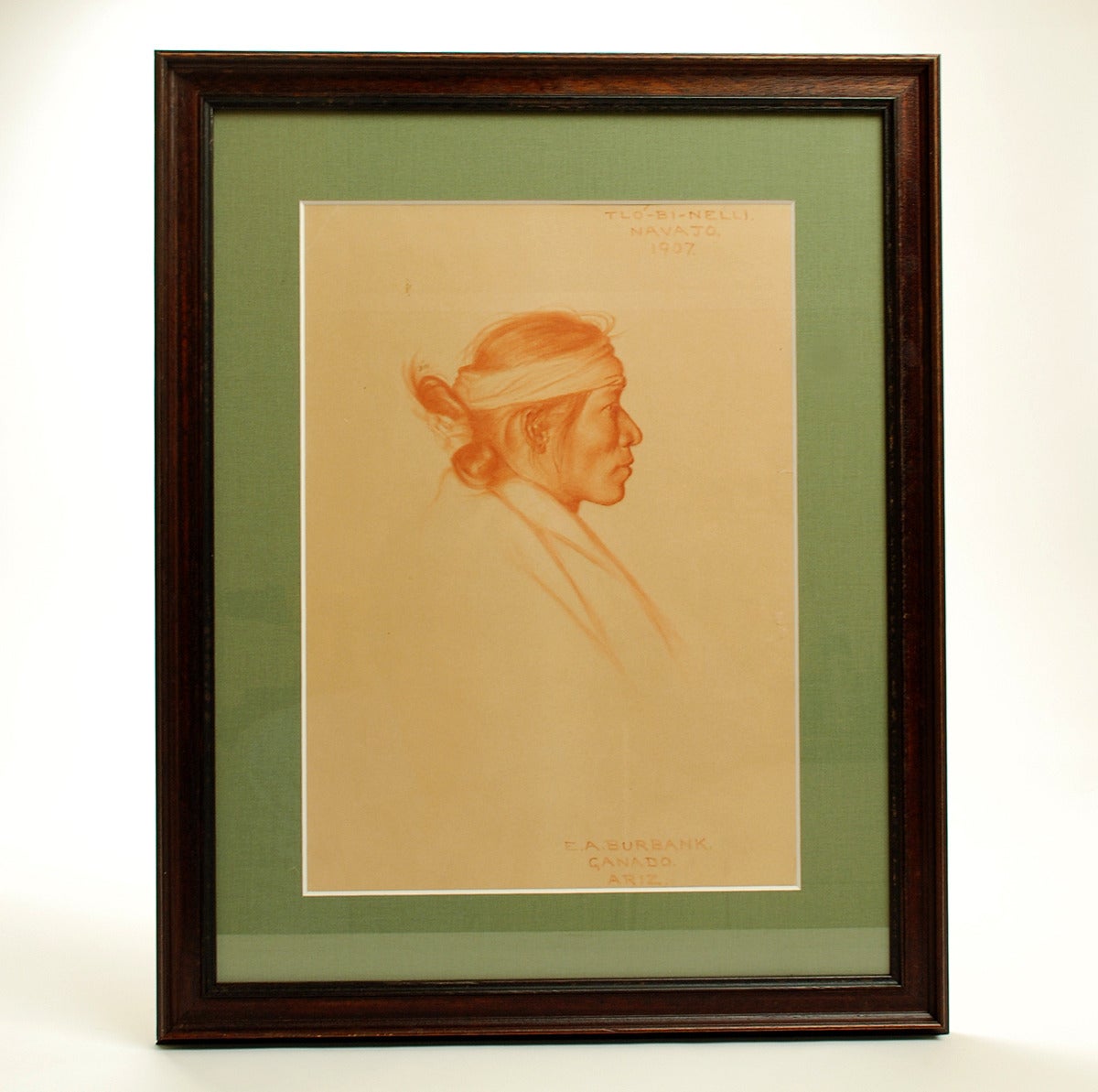Rare original Conte crayon on paper of American Indian by well listed Taos and Santa Fe school painter Elbridge Ayer Burbank (1858-1949). Signed (lower right) and inscribed 'Tlo-Bi-Nelli / Navajo / 1907' / 'E.A. Burbank. Ganado,