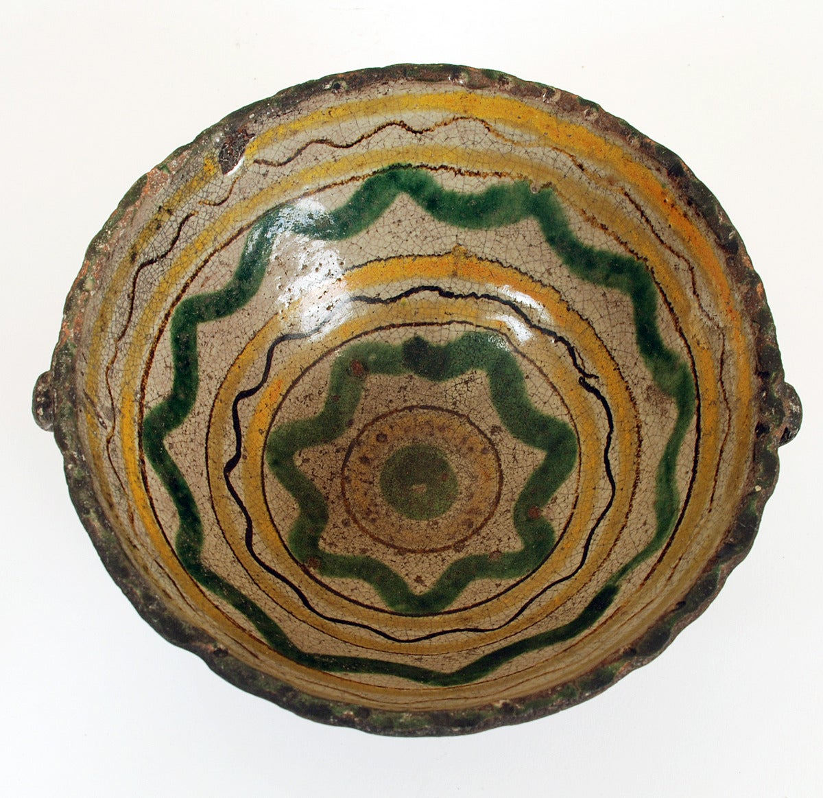 A colorful late 19th century majolica bowl, made by the Montiel Family Studio in Antigua, Guatemala - circa 1890 - 1900. Overall with excellent wear and surface patina.

Dimensions: 9.5 inches diameter x 4 inches high.

In excellent, original