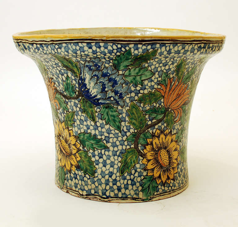 A very large and impressive Antique Mexican talavera Poblana 'florera' with colorful sunflower motifs surrounded by blue and white mosaics. The underside bears the 'Guevara Family' signature (La Trinidad Studio). Circa 1900 - 1920. 

* The silver