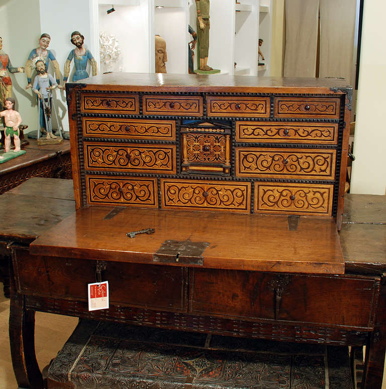 A gorgeous mid 18th century Spanish cedar-wood bargueño with fine mahogany and citrus wood inlays. The interior with twelve inlaid drawers, each surrounded by hand carved ebony trim. Original iron hardware backed in original English felt together