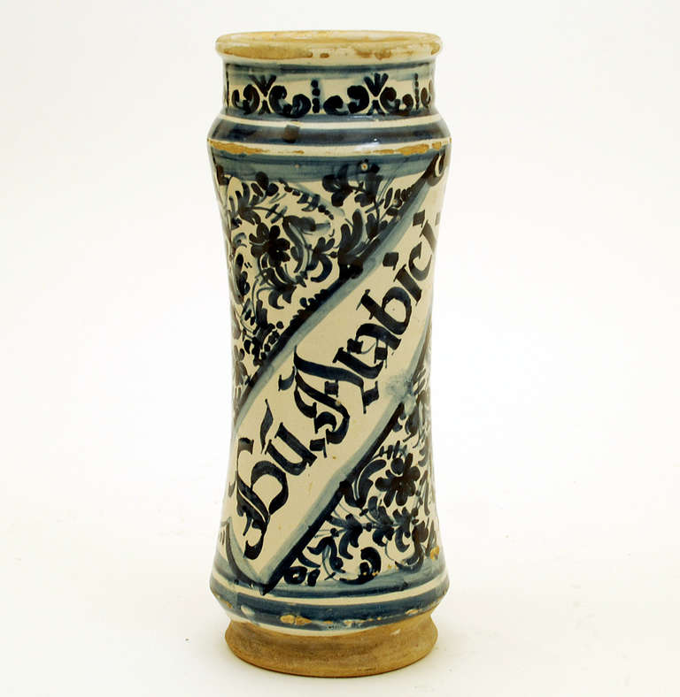 A superb mid 18th century talavera Poblana blue on white albarello (apothecary jar) with graphic foliate and geometric motifs in deep cobalt over a milk white slip. Inscribed 'Gu Arabici', for 'Gum Arabic', a natural gum sap harvested from two