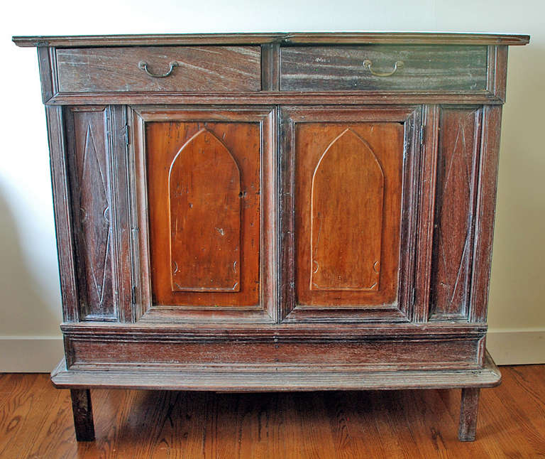 A good early 19th century Filipino cómoda with rectangular single board top over two drawers and raised panel doors terminating into block feet. Narra mahogany with jack-fruit wood doors. Original hardware. Overall with excellent color, wear and