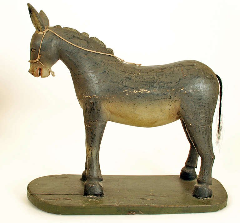 A large mid 19th century Mexican creche burro, carved and polychrome painted wood with inset glass eyes and horse hair tail. Condition: in overall excellent, original condition.
The mask is shown for scale only and is not part of this listing.