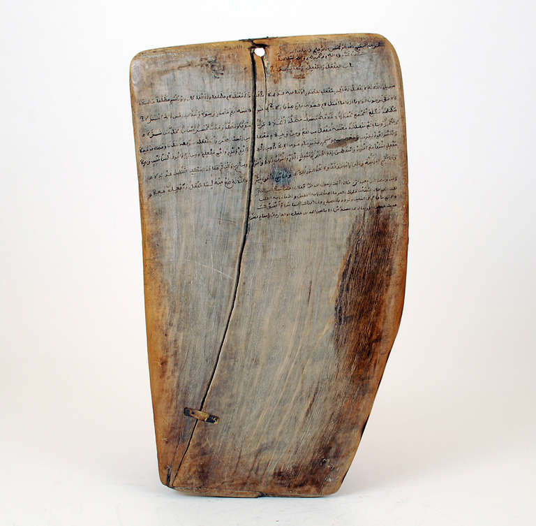 This early 20th century cedar-wood tablet (circa 1930s) is a hand painted Quranic teaching tablet from Morocco. Quranic tablets were used in Moroccan Madrasah to help students learn Quranic scripture, a teaching tool that dates back centuries, and