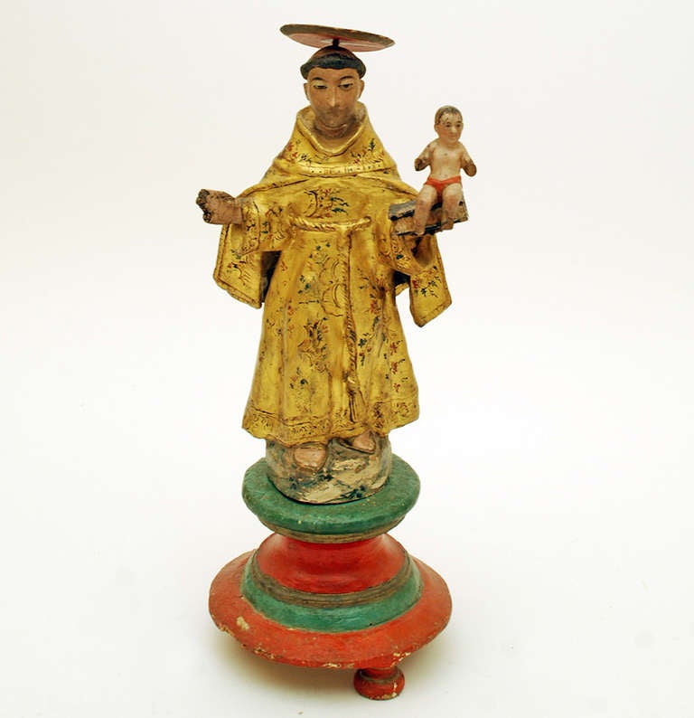 A superb 18th century Spanish colonial Saint Anthony sculpture. Carved and polychrome painted wood with beautiful giltwood tunic in the Chinoiserie style. Inset glass eyes. Original hand painted pedestal base with original bun feet. Circa 1775. In