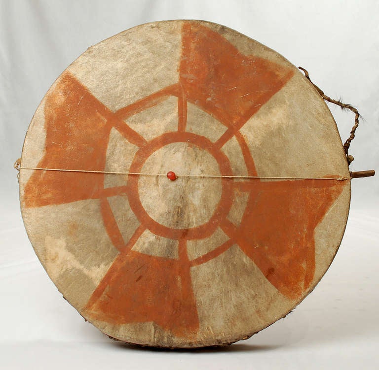 A large and impressive early 20th century Tarahumara Indian painted ceremonial drum from the Copper Canyon, deep in Sierra Madre mountains of Northwestern Mexico -- circa 1940's. Bent yellow pine stretched in rawhide and finished in iron oxide based