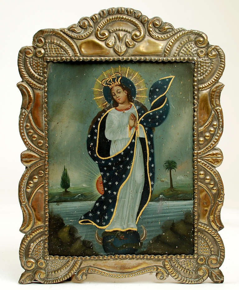 A superb 19th century oil on tin retablo painting of 'La Purisima Concepcion', flanked by a palm and a cypress and surrounded by an aura of radiant light. Displayed in a wonderful 19th century hand chased and repousse copper frame - a work of art in