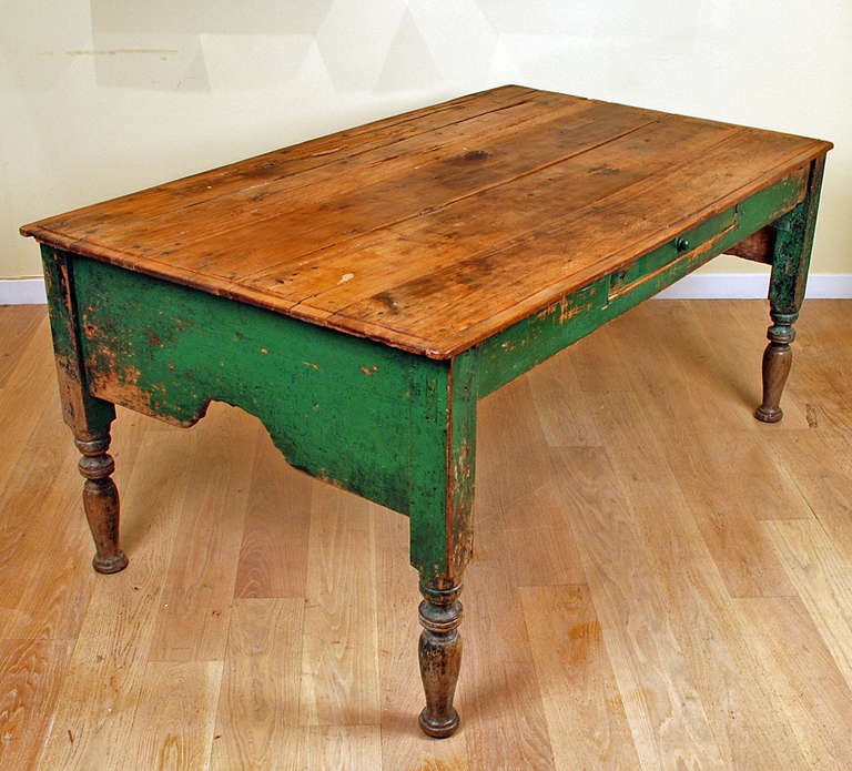 A large and impressive early 19th century Mexican painted hacienda table with large scalloped skirt. turned legs, dovetailed drawer and original apple green paint -- overall with excellent wear and patina. 

Dimensions: 69 inches long x 39 inches