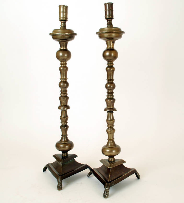 A pair of exceptionally fine and rare 18th century Spanish colonial bronze candlesticks. Mexico, circa 1775.

The colonial silver charger is shown for scale only and is not part of this listing.

Dimensions: 29.5 inches high.  

Condition: in