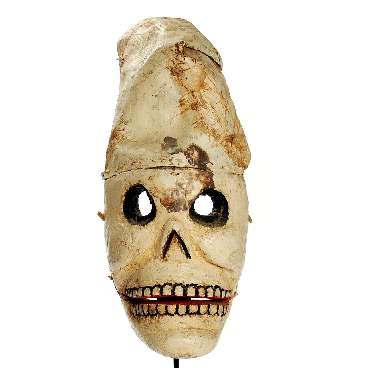 A superb early 20th century Mexican 'muerte' mask (death mask) from Guerrero, circa 1920s-1930s. Hand-carved and polychrome painted wood together with hand-stitched and molded leather soccer ball helmet. The jaw is articulated, with a knotted hinge