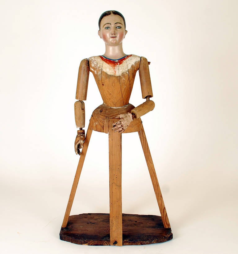 A superb mid-19th century bastidor (cage) santo with inset glass eyes, articulated arms, jointed at the elbow and shoulder, together with the original cage base. Overall with excellent wear and surface patina. In excellent, original condition.