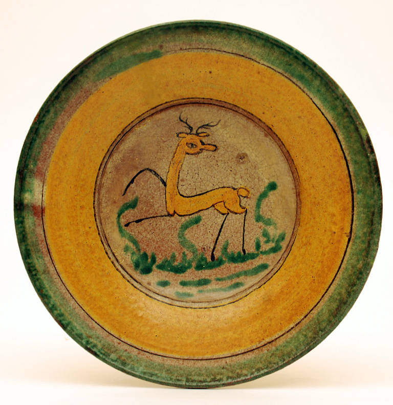 A rare late 19th century 'Montiel' plate from the 'Montiel Family Studio' in Antigua Guatemala. A playful deer surrounded by foliage and yellow ring borders. See Marion Oettinger's 'Folk Art of Spain and the Americas' for a similar Montiel studio