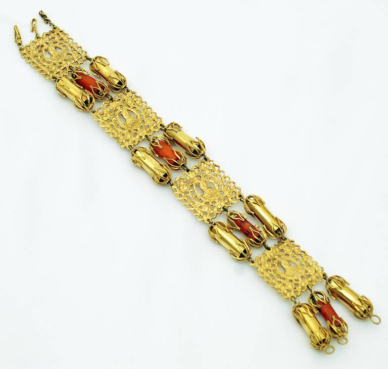 A very rare late 19th century 18-karat gold 'pulseira escrava' (slave bracelet), made for and worn by the mistresses of wealthy Brazilian hacienda owners. The bracelet features four gold interlaced plaques, connected by gold, gold filigree and coral