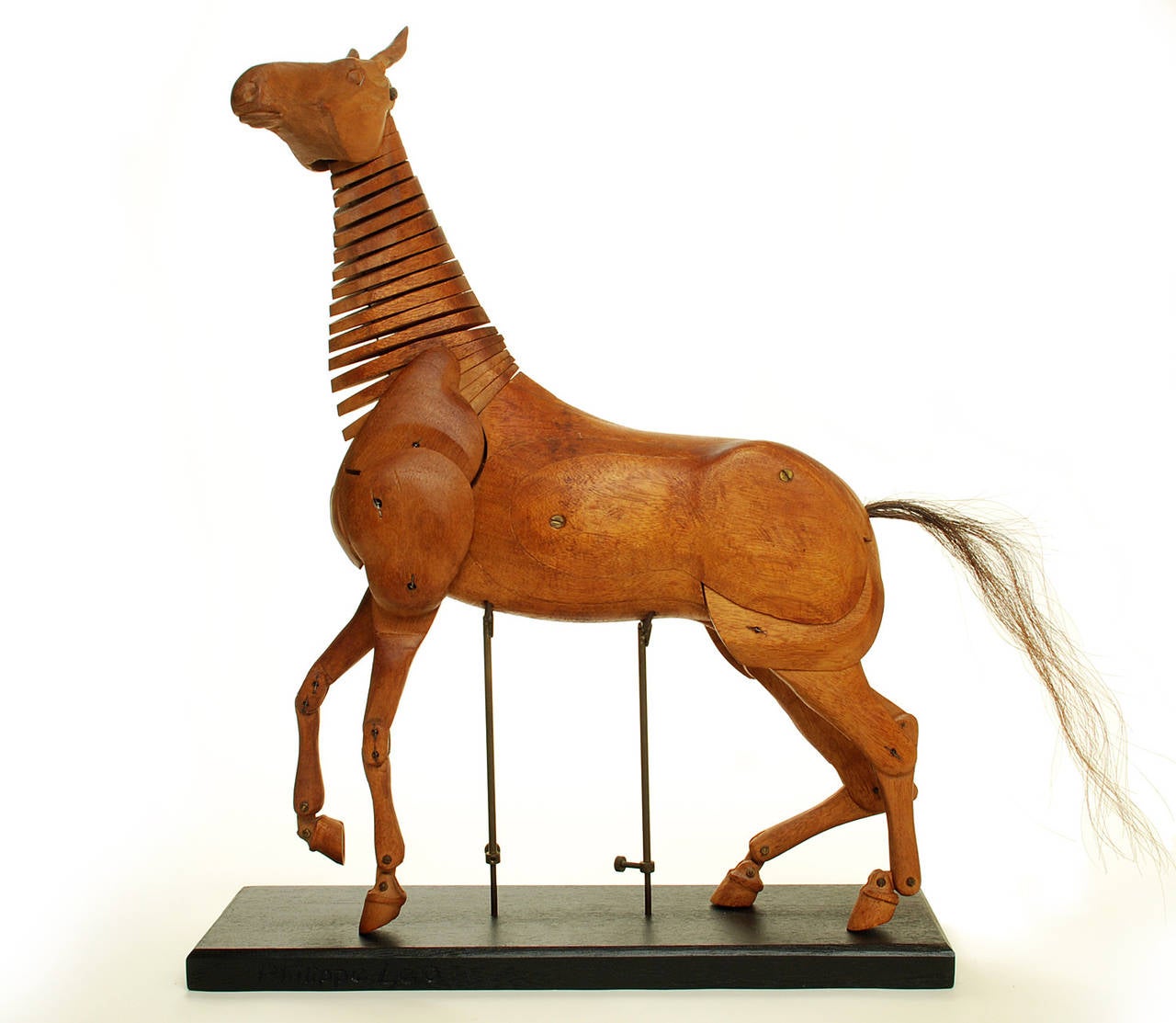 Outstanding vintage hand-carved mahogany artist's model of a horse -- articulated at almost every level, including the hand-carved wooden ears. Artist signed along the side of the base: Philippe Leo.

Dimensions: Horse measures 29 inches long in