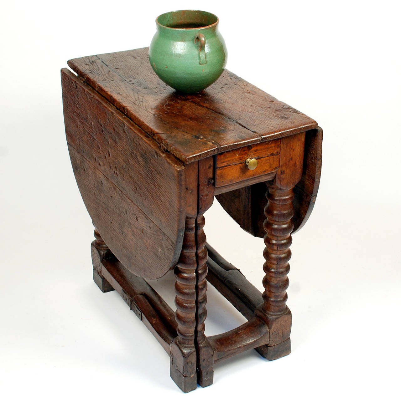 This early 18th century gate-leg table, made entirely of 'sweet' chestnut from Spain's Basque Country, was fashioned after the nearly ubiquitous English made model. This Spanish edition however, is anything but ubiquitous. To the contrary, this