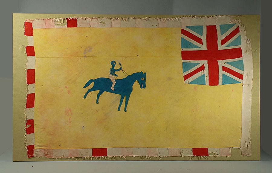 A stunning early 20th century colonial Asafo Fante flag from Ghana - circa 1940. Large cotton panels with applique horse and rider, Union Jack in upper right and colorful multi-striped border. Professionally backed, stretched and mounted.<br />
<br