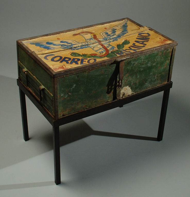 A one of a kind early 20th century hand painted Mexican mail courier's postal strongbox with the Mexican eagle and serpent against a yellow background. Inscribed 'Correo Mexicano.' Large iron handles with barrel hinges and original strap hinges.