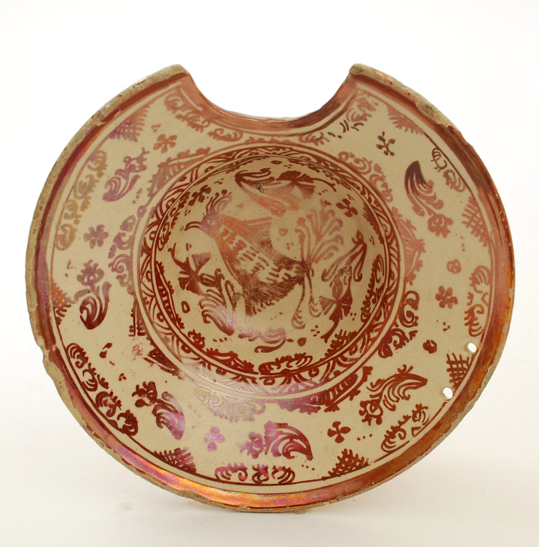 A very rare 18th century Hispano-Moresque lusterware bowl in deep copper over a milk white slip. Classic paralot bird motif surrounded by foliage and geometric patterns. This extremely rare form is a 'shaving' or barber's' bowl, with a deliberate