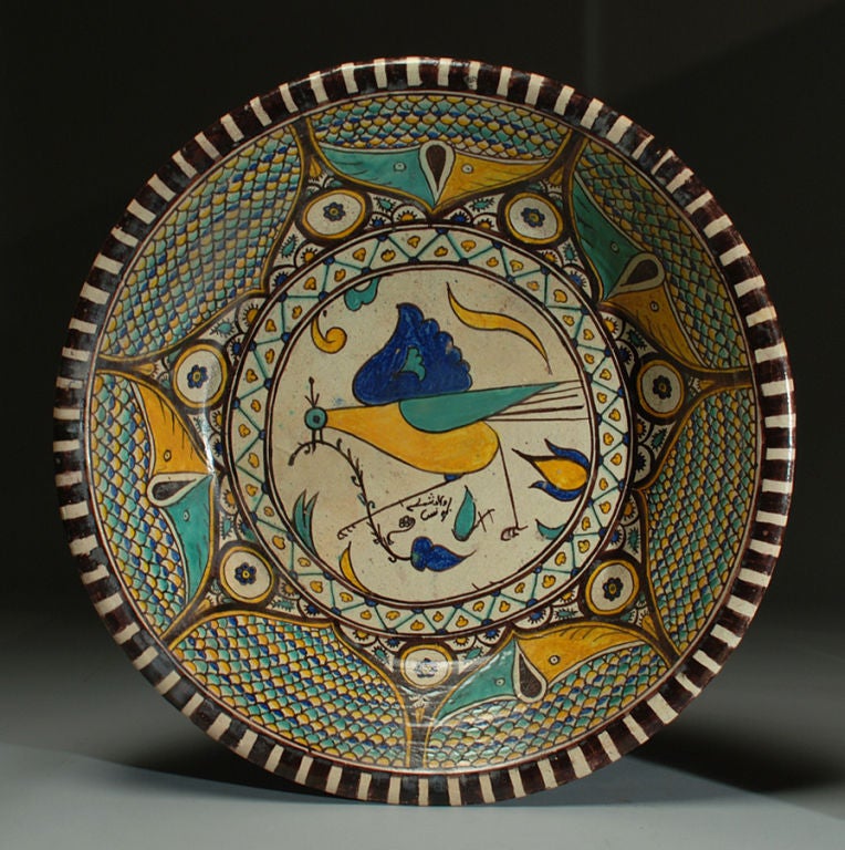 A stunning 19th century Moroccan lebrillo (basin) with a beautiful bird surrounded by stylized flowers and geometric motifs. Inscription or signature on obverse and reverse. The Spanish blue on white charger is shown for scale only and is not part