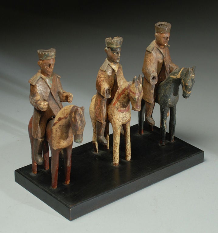 A finely sculpted 19th century 'Caban' family 'Tres Reyes Magos' from Puerto Rico - circa 1880. Carved and polychrome painted wood on ebonized base. Old decal inscribed: 