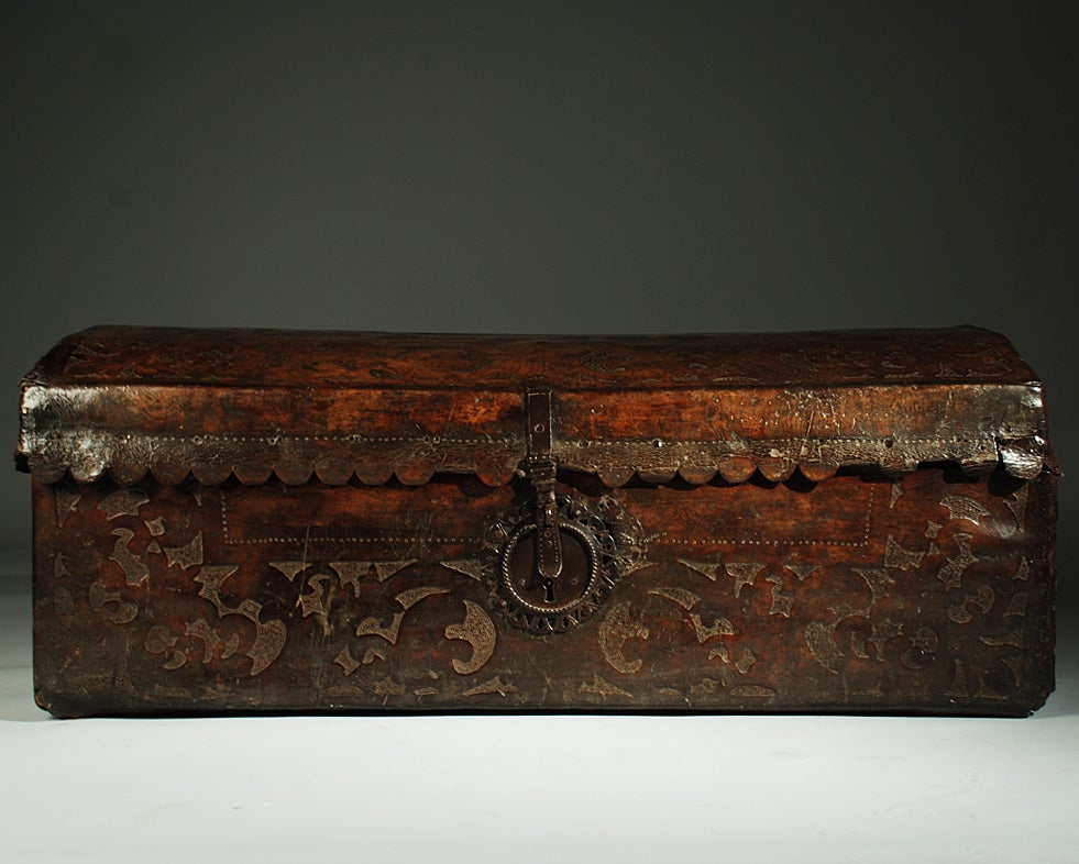 A gorgeous 17th century Spanish colonial cedar wood coffer bound in leather with beautiful hand tooled foliate motifs and stippling -- with original hand forged iron hasp, handles and lock-plate. Mexico - circa 1650. Similar 17th century Mexican