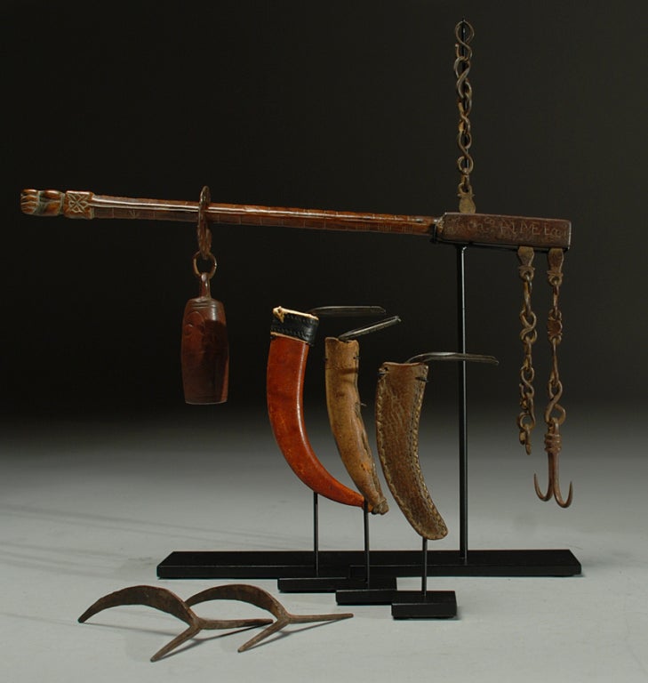 This is a very rare collection of 18th and 19th century game-cock fighting instruments from Mexico. The collection includes a Spanish colonial era wooden scale, three 19th century game-cock spurs with leather sheathes and a pair of unfinished spur