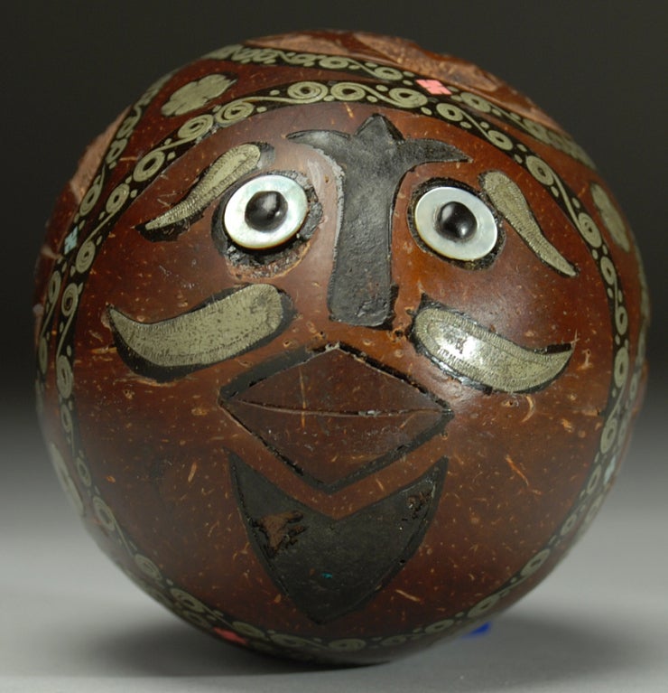 A stunning late 19th century hand carved Mexican coconut bank with beautiful silver inlay, pigmented resin and inlaid button eyes - circa 1880 -1900. Most likely from the infamous 'San Juan de Ulua' prison in Veracruz.<br />
<br />
Dimensions: